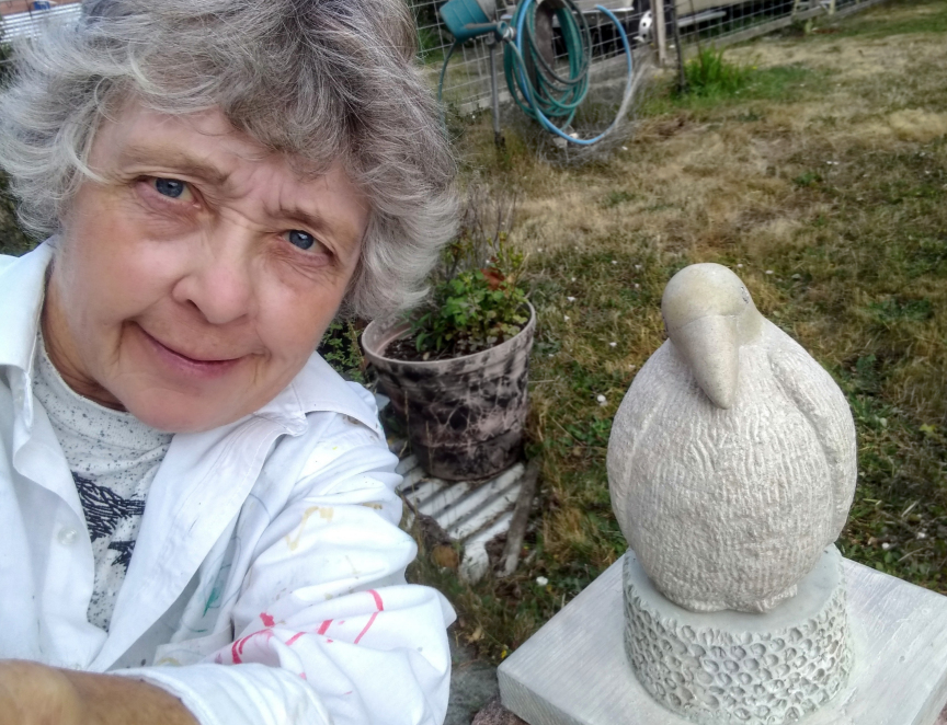 Photo of artist with first stone sculpture