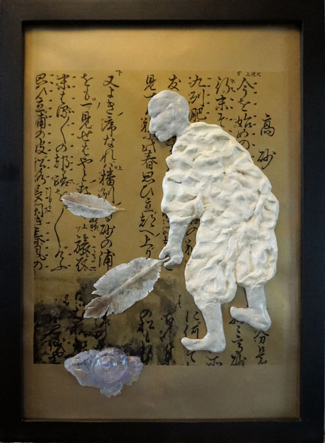 Photo of mixed media art featuring a draped worker figure